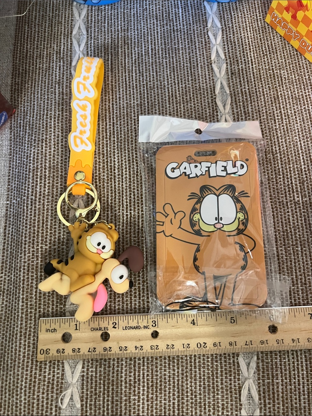 Character keychain with character, badge, and lanyard